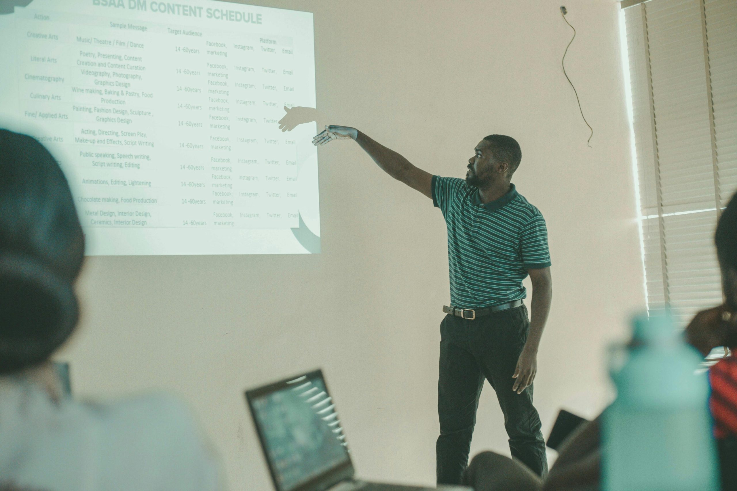 pexels-oloruntoba-john-104292376-15225230 Man presenting a powerpoint