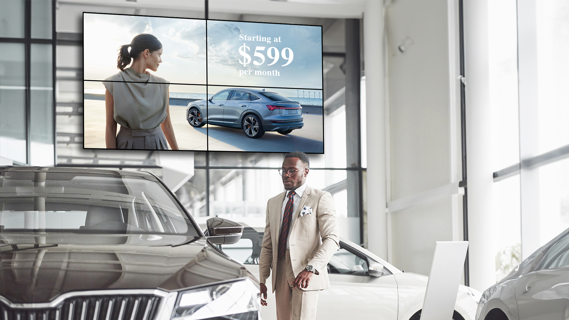 Digital signage_car dealership Man in a showroom infant of a digital sign
